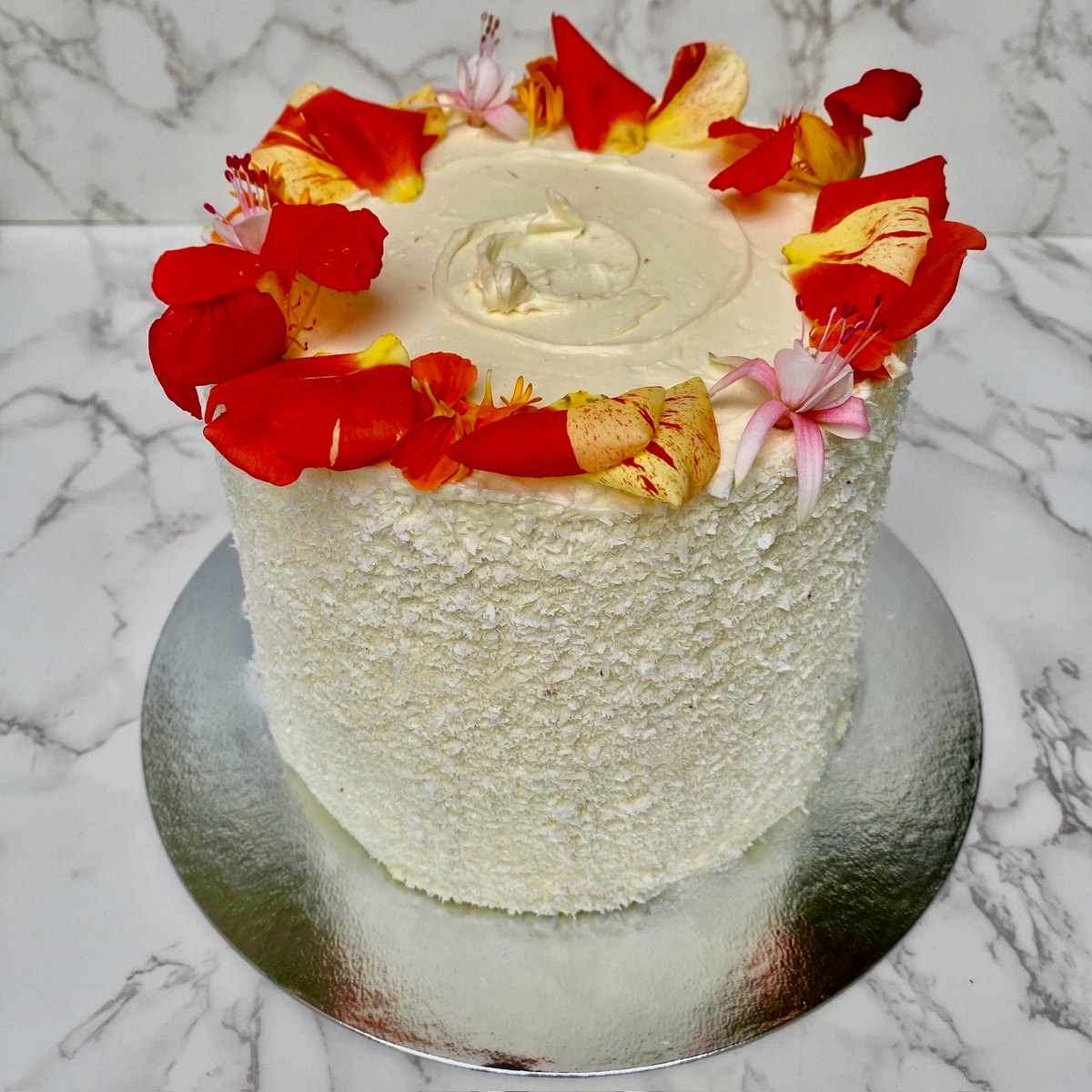 Coconut mango cake slice showing passion fruit curd filling