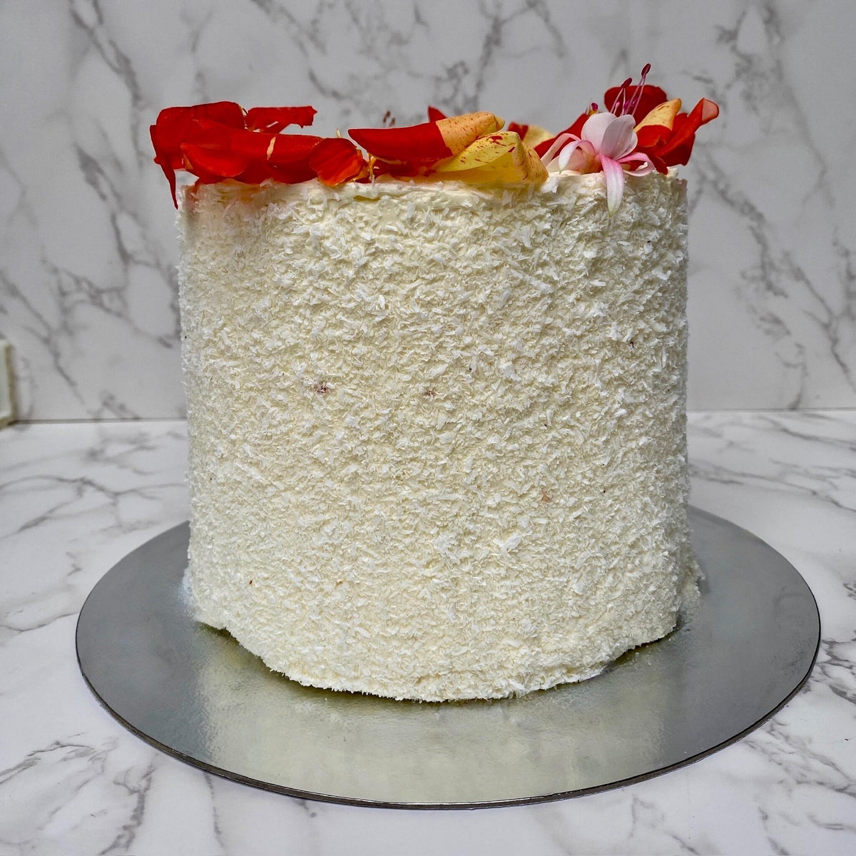 Coconut sponge cake close up with mango topping